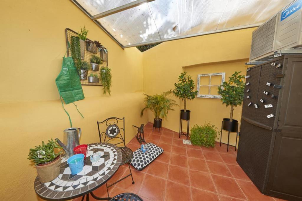a room with a table and some potted plants at Lx Factory Apartment! Outside terrace in Lisbon