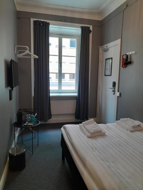 Postel nebo postele na pokoji v ubytování Birka Hotel