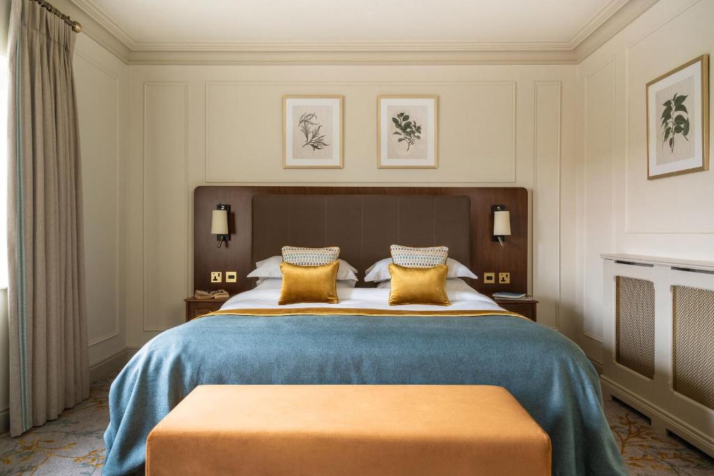 a bedroom with a large bed with yellow pillows at Lough Erne Resort in Enniskillen