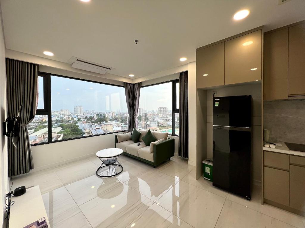 a living room with a couch and a large window at Zhome-2BR apartment in Kingdom101-District 10 in Ho Chi Minh City