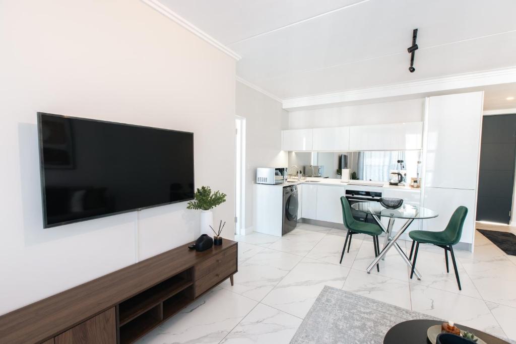 a living room with a flat screen tv on a wall at City Nest: Heart of Linksfield in Johannesburg