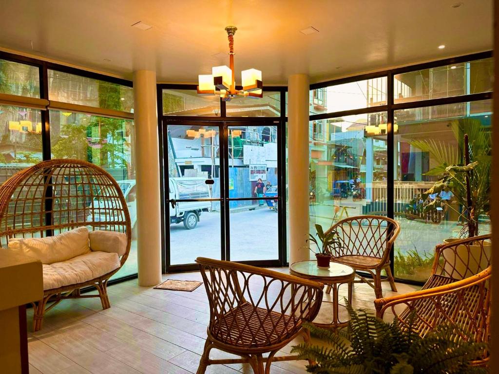 - un salon avec un canapé, une table et des chaises dans l'établissement Vencejos Inn - El Nido, à El Nido