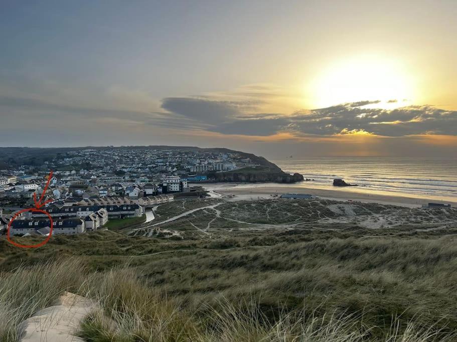 a view of a beach with a city and the ocean at Direct Beach Access! Top Floor Apartment Perranporth in Perranporth