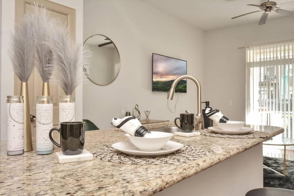 a bathroom with a counter with cups and utensils at Stars In The Moon Fully Furnished in Houston