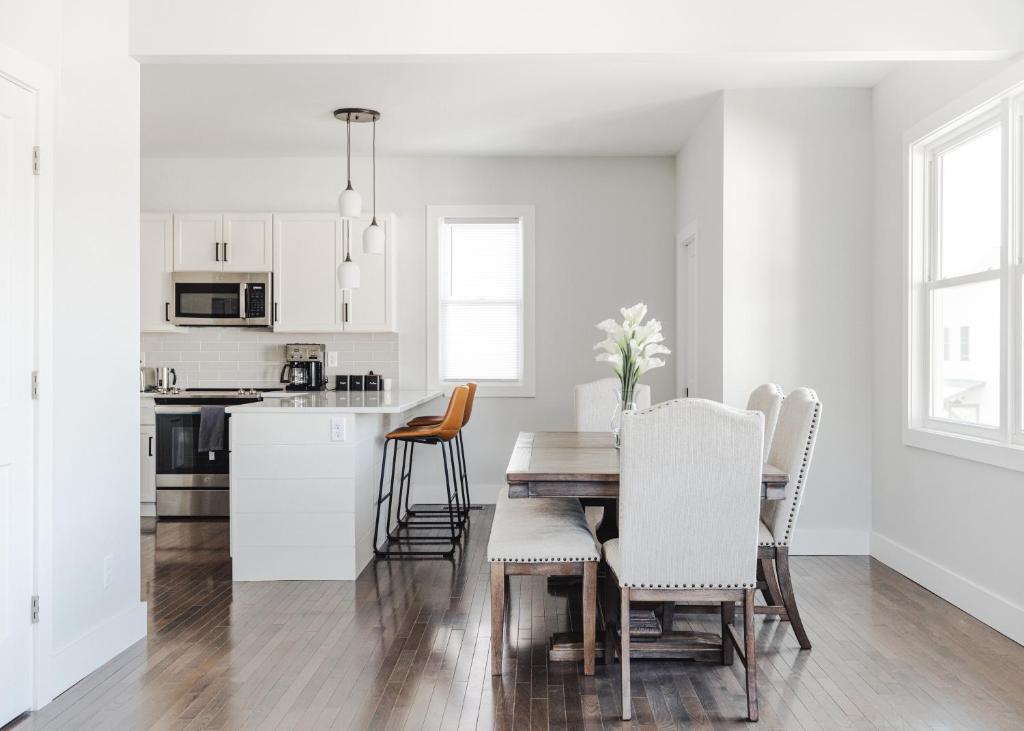 a kitchen and dining room with a table and chairs at Tranquil River Home in Asheville