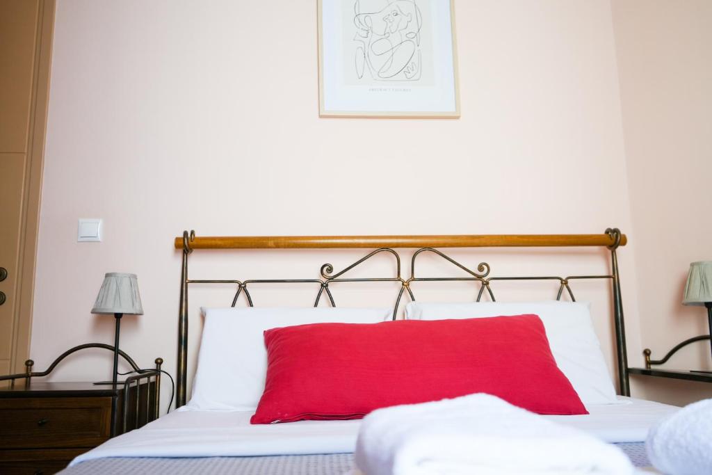 A bed or beds in a room at N1 Sokaki Apartment Nafplio