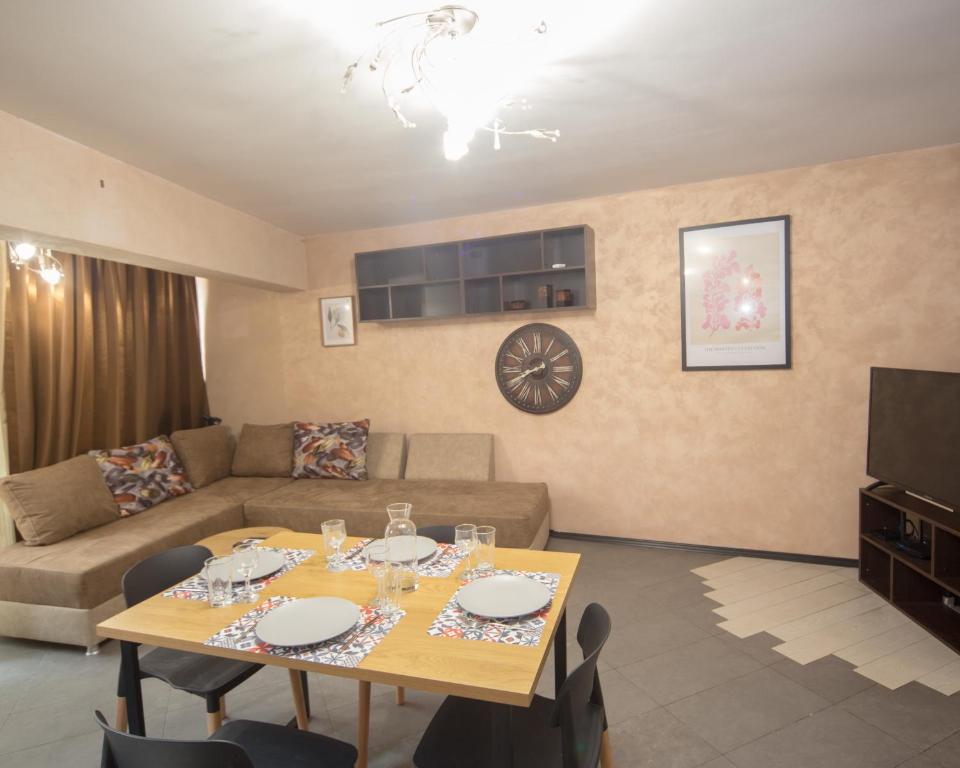 a living room with a table and a couch at Aleks Holiday-center,sea,parking in Burgas City
