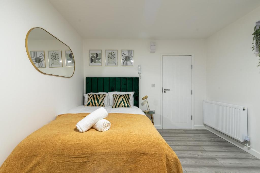 A bed or beds in a room at Exquisite Cardiff Apartments- with Garden Lounge & Games Room