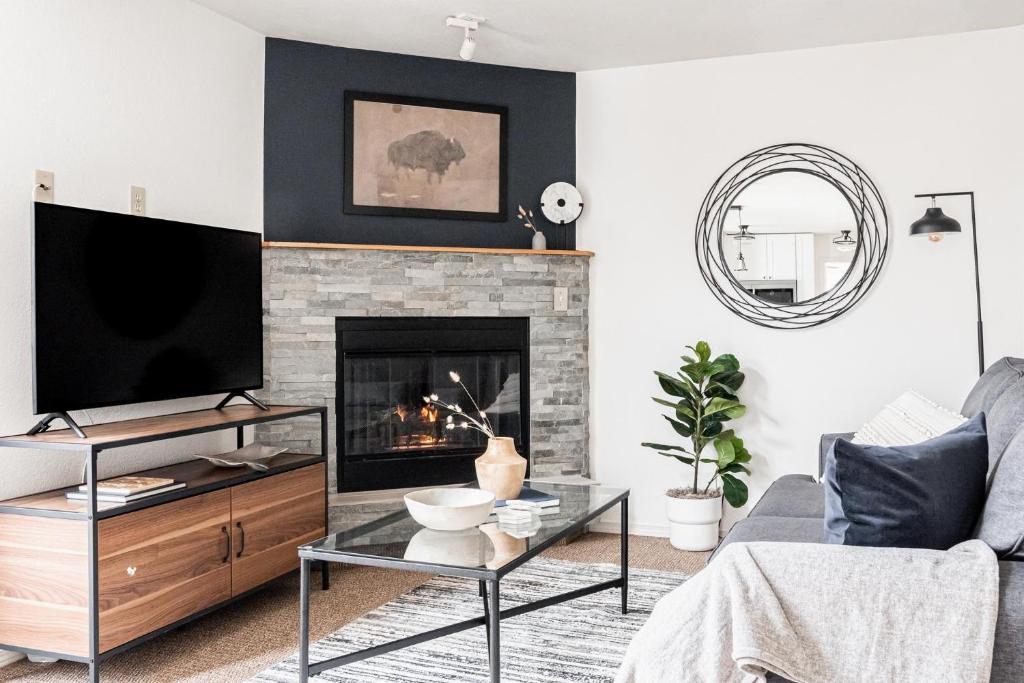 a living room with a tv and a fireplace at 1 Bedroom Apt - Gym - DTC Boston Commons in Greenwood Village