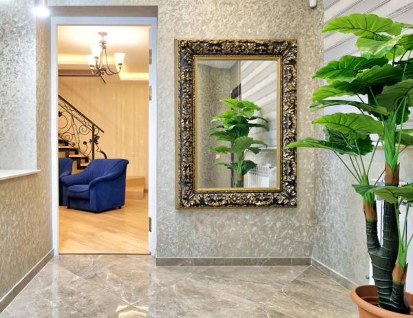 sala de estar con espejo y sofá azul en Q&B Boutique House, en Tiflis