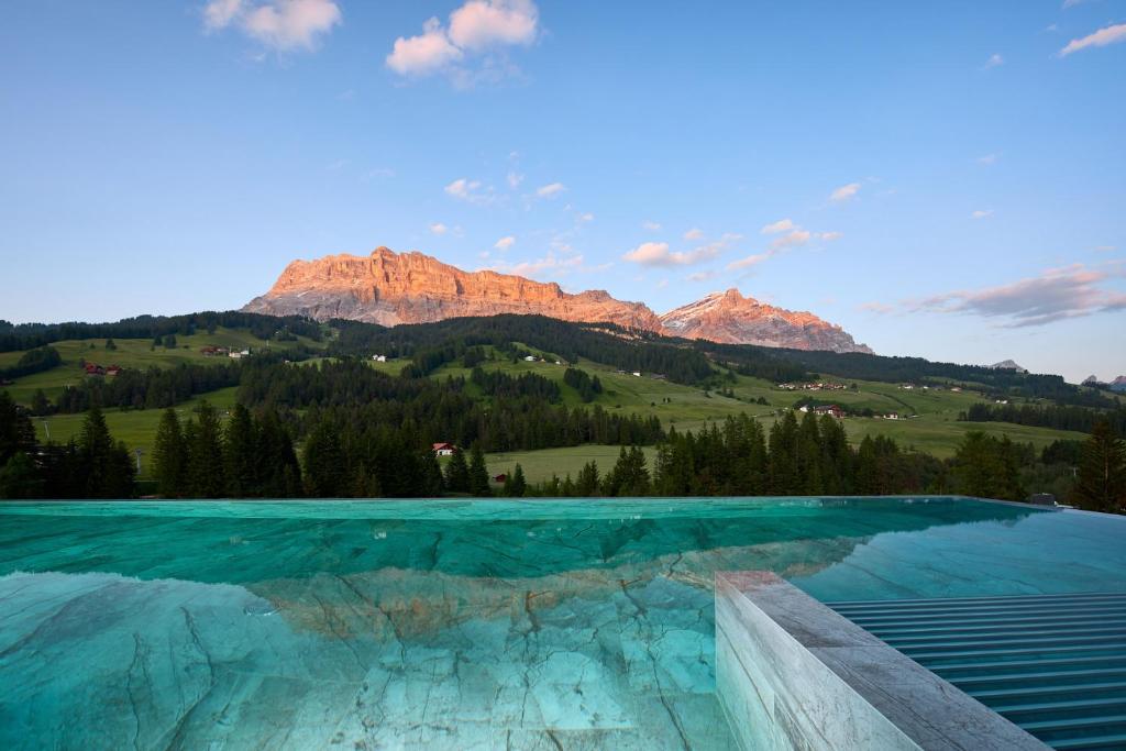 a swimming pool with mountains in the background at Badia Hill in Badia