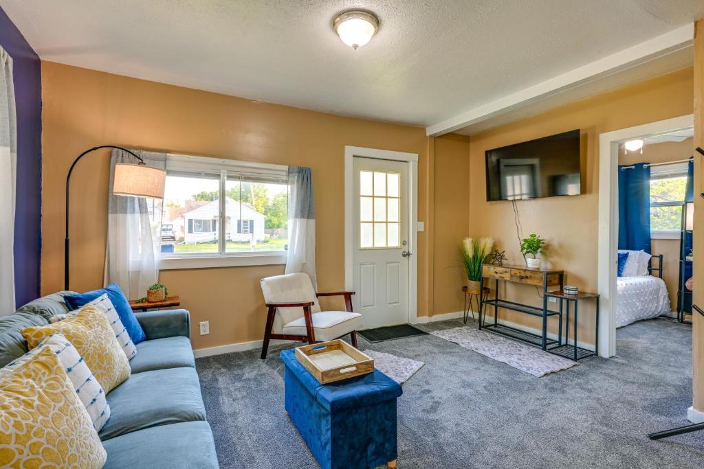 a living room with a blue couch and a table at Cozy Home with Backyard about 3 Mi to Downtown Saginaw! in Saginaw