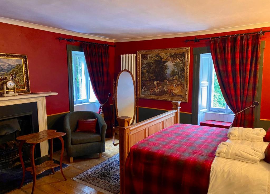 a bedroom with red walls and a bed and a chair at Organic Welltree in Saint Martins