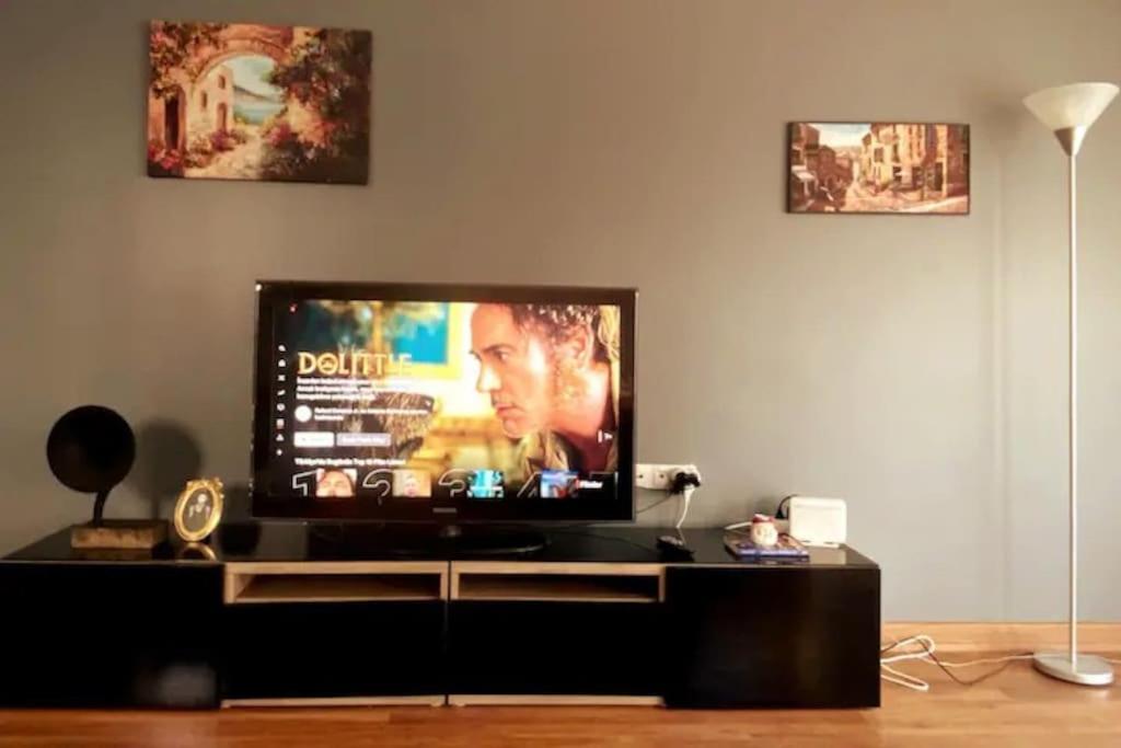 a flat screen tv sitting on a entertainment center at Duplex House in Kusadasi Marina Near Center in Kuşadası