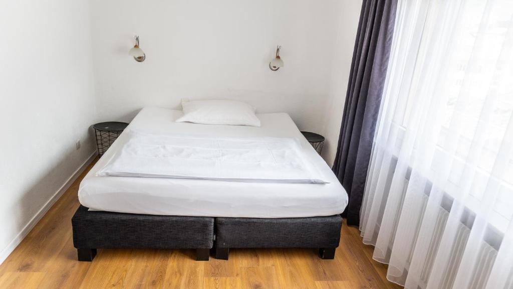 Postel nebo postele na pokoji v ubytování Hotel Europe Brig