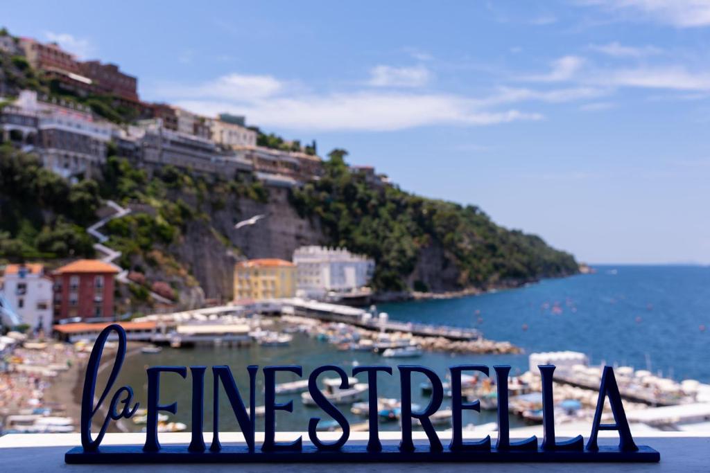 um sinal sentado no topo de uma colina perto do oceano em Relais del Mare em Sorrento