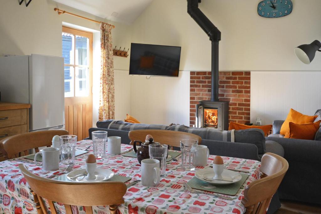 a dining room with a table and a fireplace at The Old Parlour in Frome