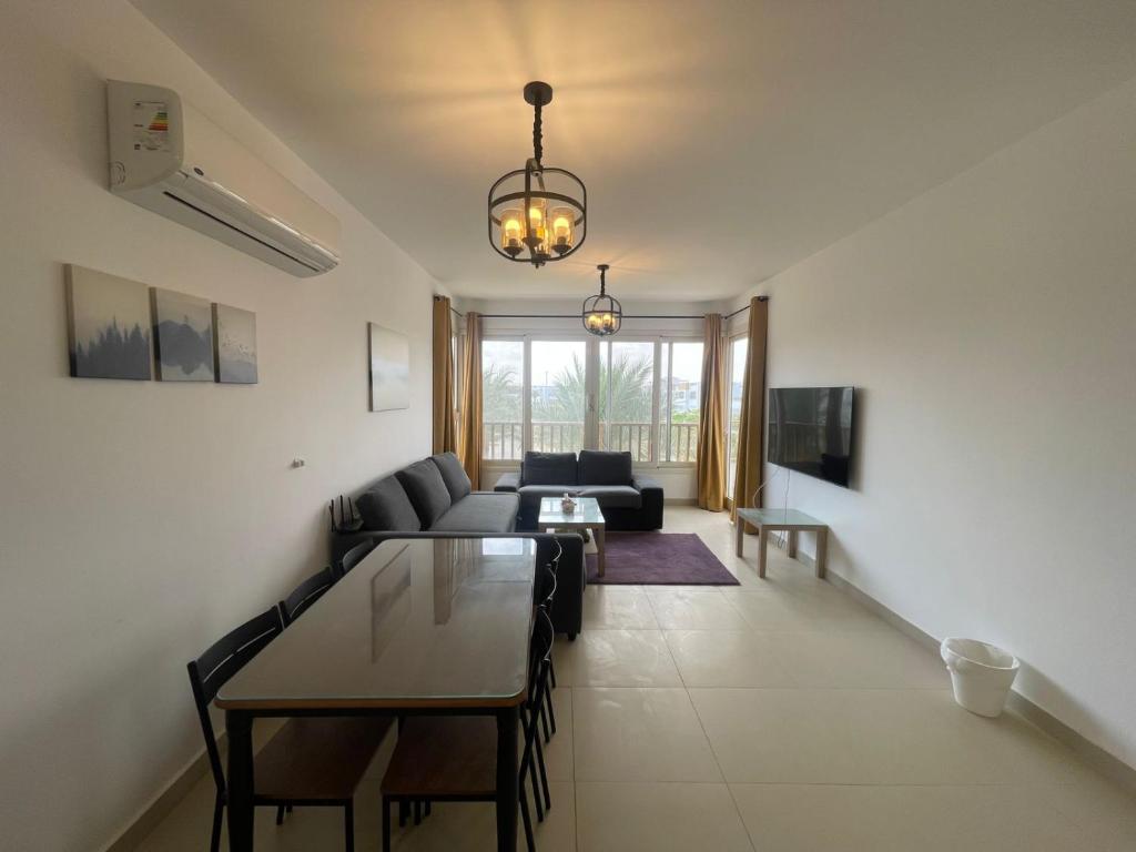 a living room with a couch and a table at Almaza Bay Beach Town Chalet in Marsa Matruh