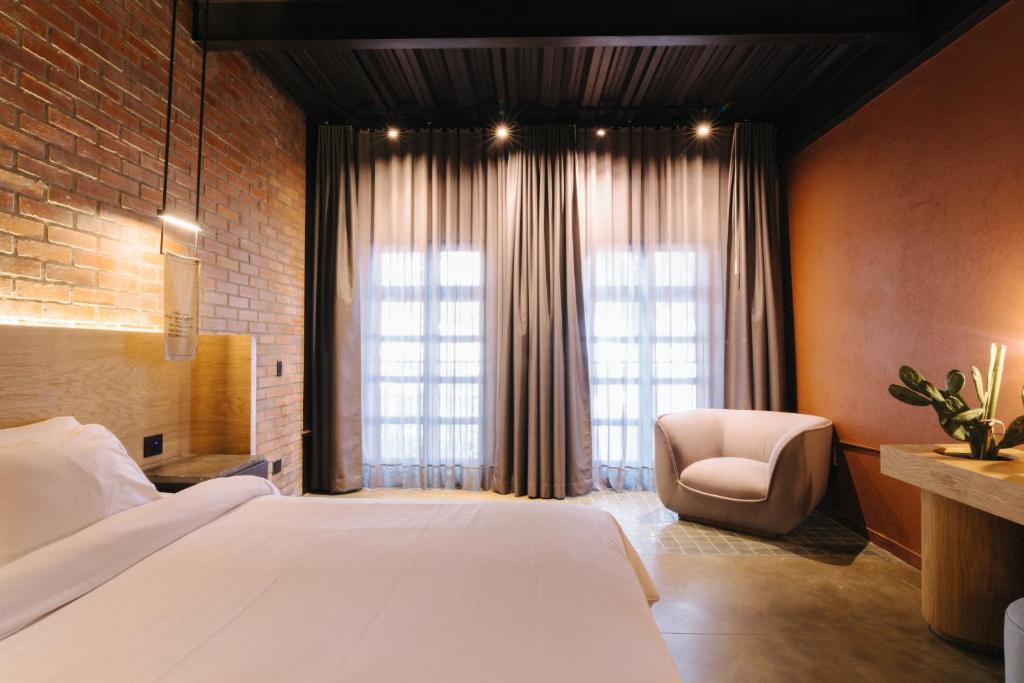 Postel nebo postele na pokoji v ubytování The Art Hotel Medellin