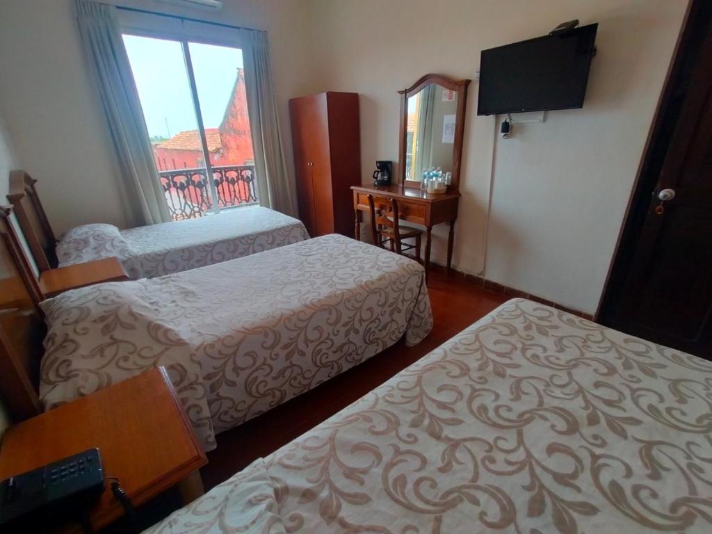 Postel nebo postele na pokoji v ubytování Hotel Posada Doña Lala