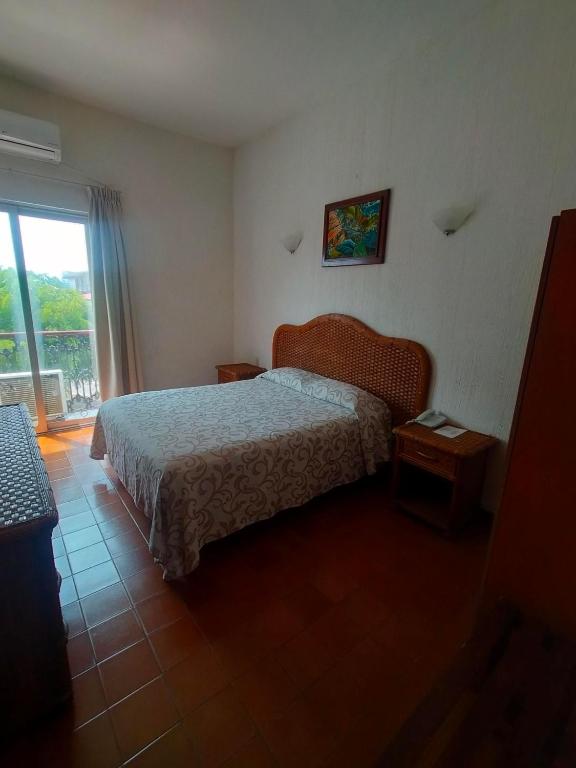 Postel nebo postele na pokoji v ubytování Hotel Posada Doña Lala