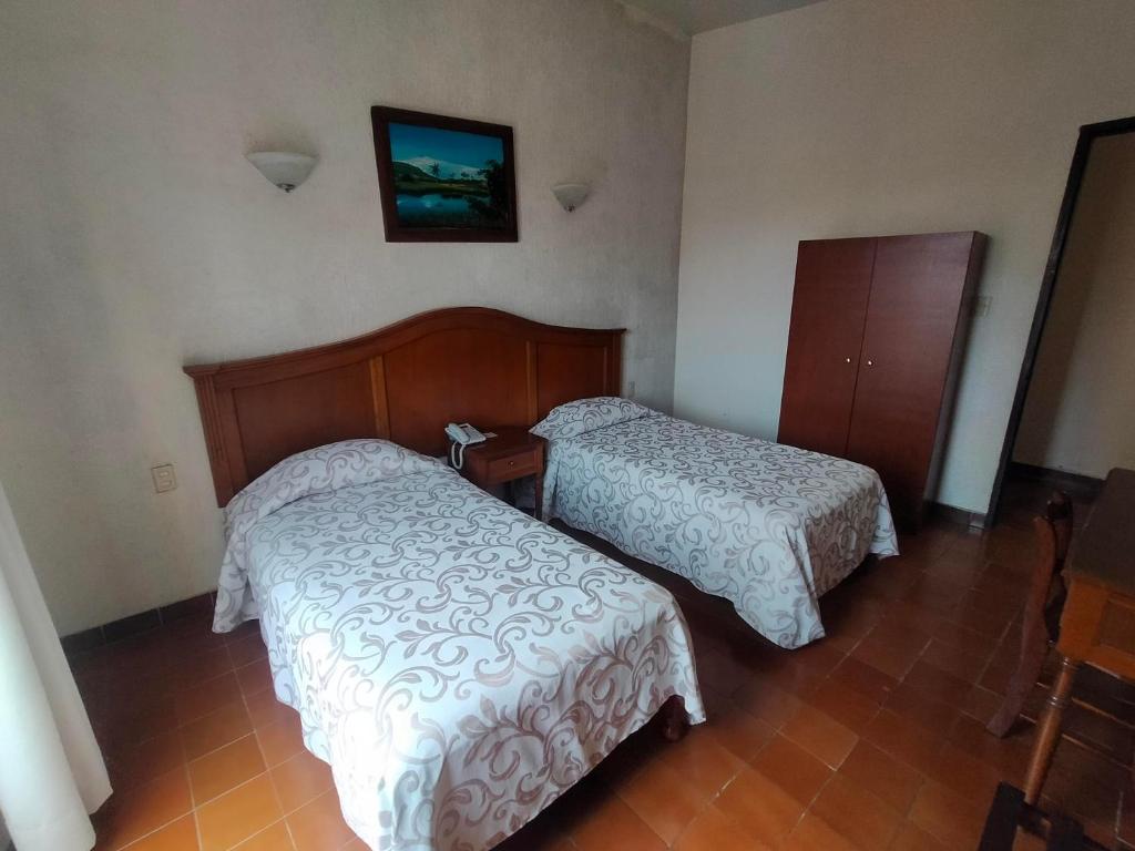 Postel nebo postele na pokoji v ubytování Hotel Posada Doña Lala