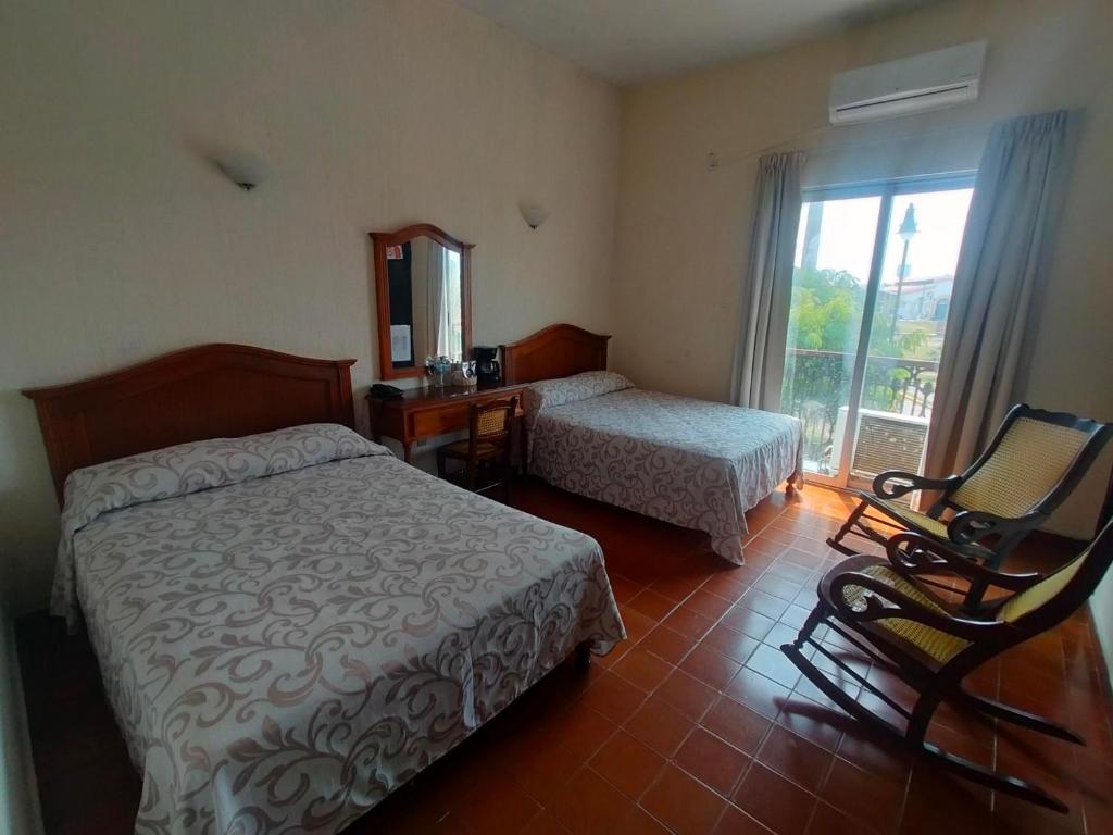 Postel nebo postele na pokoji v ubytování Hotel Posada Doña Lala
