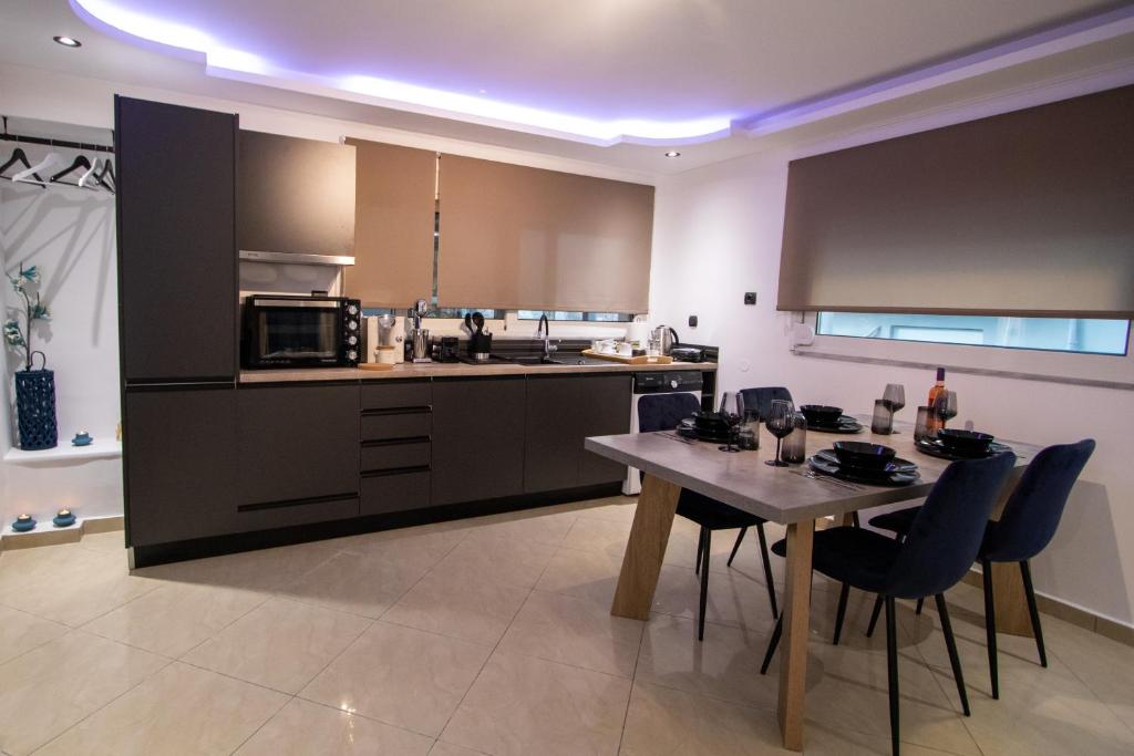 a kitchen with a table and chairs in a room at Black Suites in Chania Town