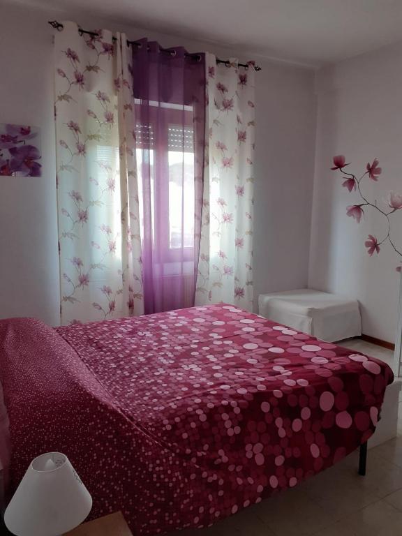 Łóżko lub łóżka w pokoju w obiekcie L'Orchidea di Ale