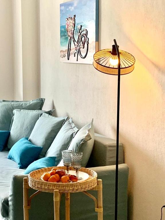 a living room with a couch and a table with fruit on it at Blue Lagoon in Nikiti