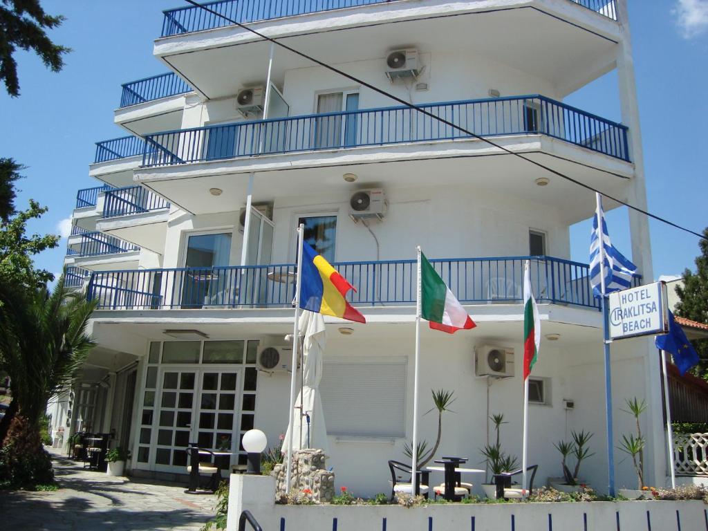 a white building with flags in front of it at Iraklitsa Beach in Iraklitsa