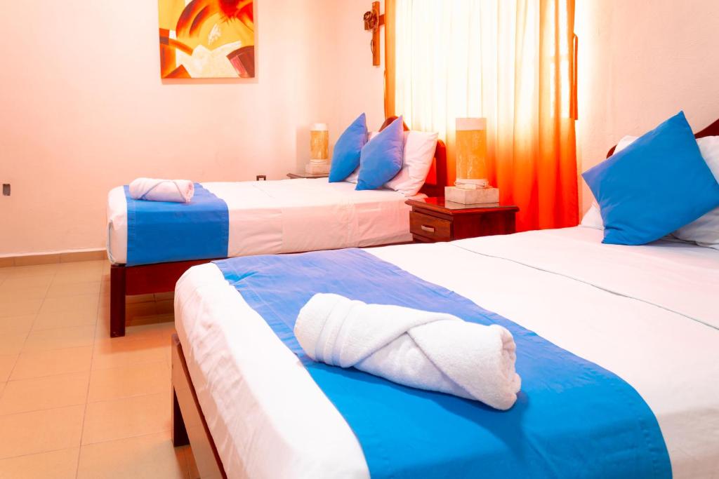 Postel nebo postele na pokoji v ubytování Hotel Bacalar Magico