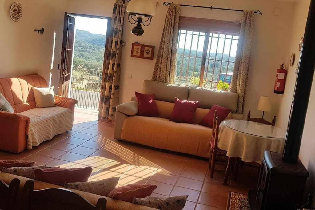 a living room with a couch and a table at Casa Rural Paraiso de Emilia in La Aulaga