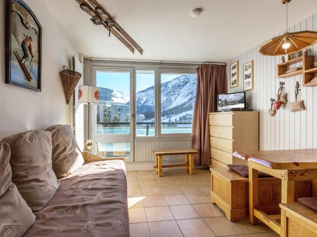 a living room with a couch and a table at Studio Val-d'Isère, 1 pièce, 4 personnes - FR-1-694-81 in Val-d'Isère