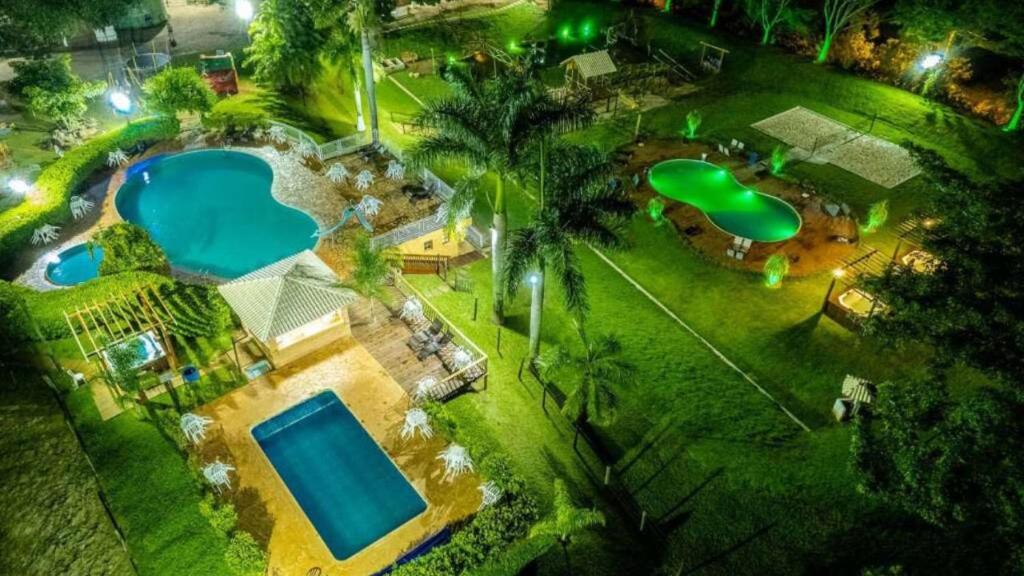 an overhead view of two swimming pools in a yard at Santana's Ranch in São Pedro