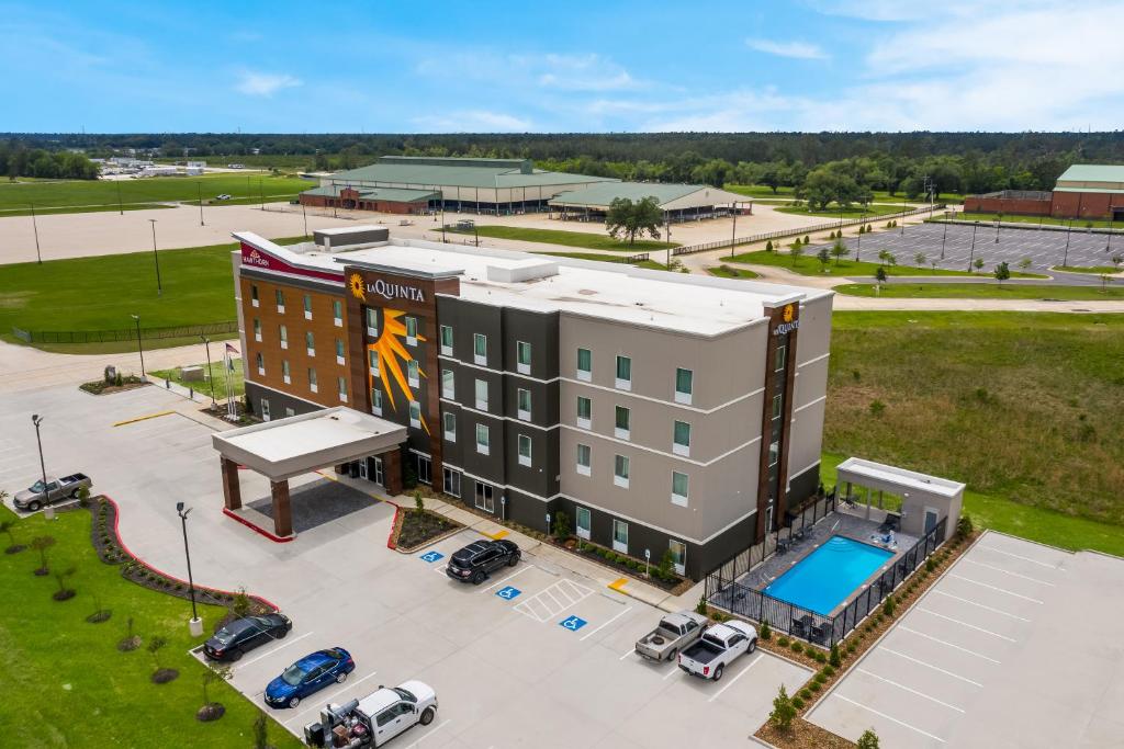 an aerial view of a hotel with a parking lot at La Quinta Inn & Suites by Wyndham Sulphur Lake Charles in Sulphur