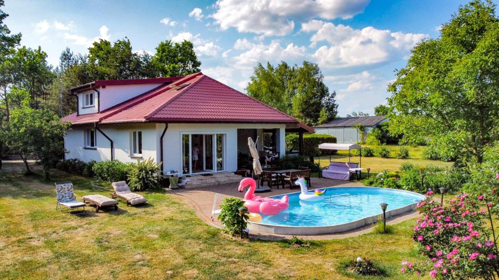 una pequeña casa con piscina en el patio en Zielone Siedlisko, 