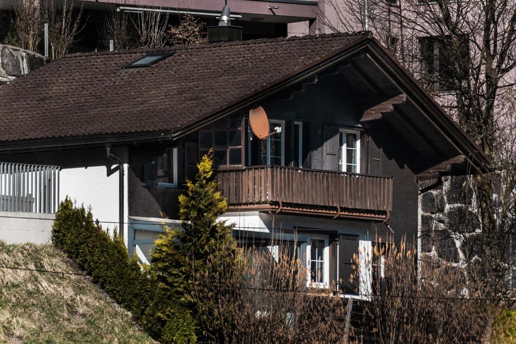 a house with a balcony on top of it at Chalet Casita in Engelberg