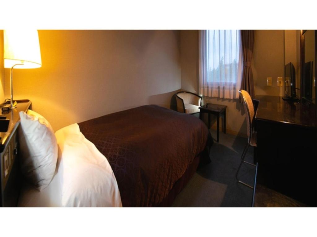 Ένα ή περισσότερα κρεβάτια σε δωμάτιο στο Hotel Satsukien - Vacation STAY 75956v