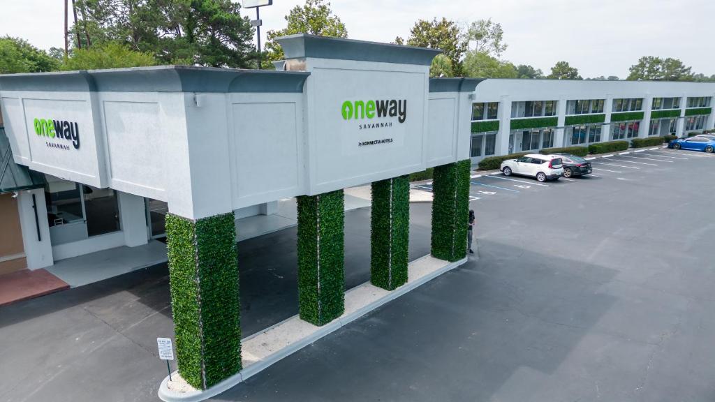 a building with green columns in a parking lot at Oneway Savannah in Savannah