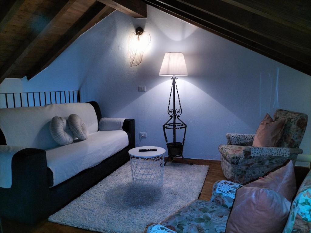ein Wohnzimmer mit einem Sofa und einem Stuhl in der Unterkunft Casa Varenne in Stropino
