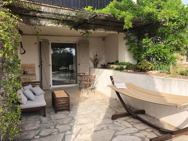 an outdoor patio with a couch and a table at A casa dolce in Le Castellet