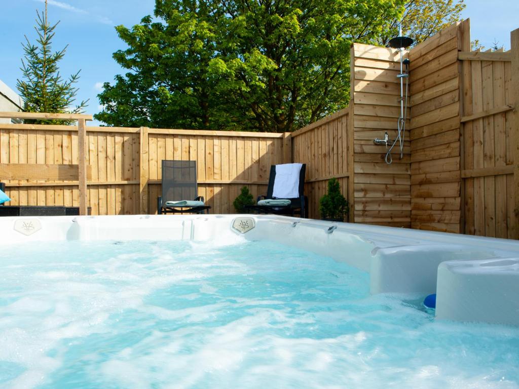 a swimming pool in a backyard with a wooden fence at The Ramblers' Rest - Princetown in Princetown