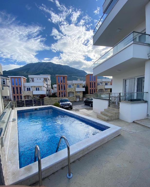 a large swimming pool on the side of a building at Emma Lux Apartment in Dobra Voda