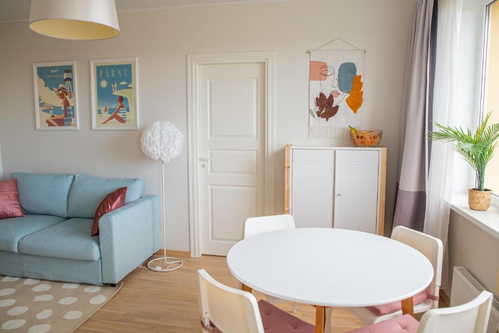 a living room with a blue couch and a table at Oja residents in Pärnu