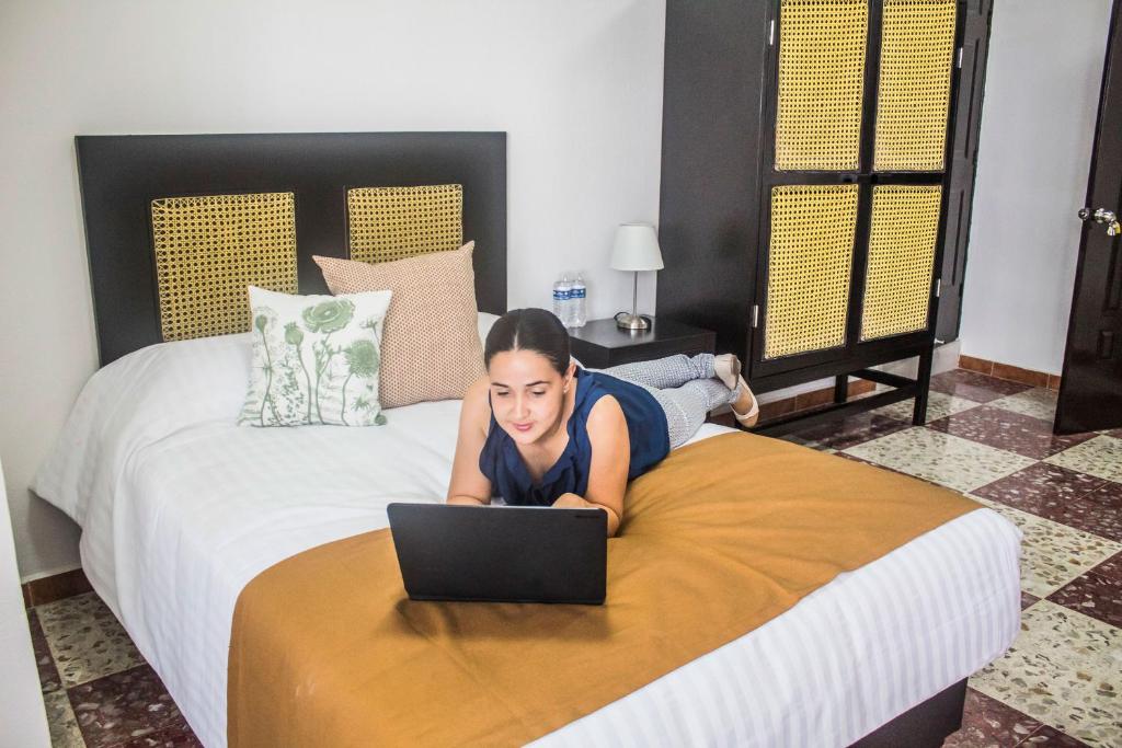 Postel nebo postele na pokoji v ubytování Múcara hotel