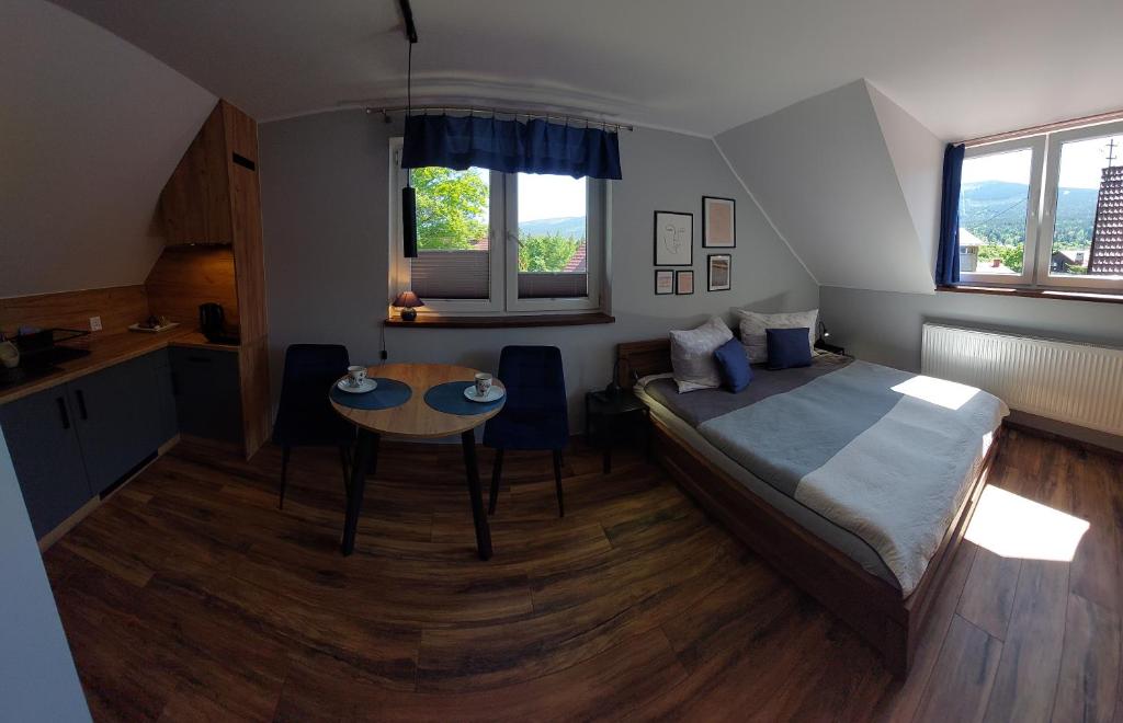 Postel nebo postele na pokoji v ubytování Willa pod lasem