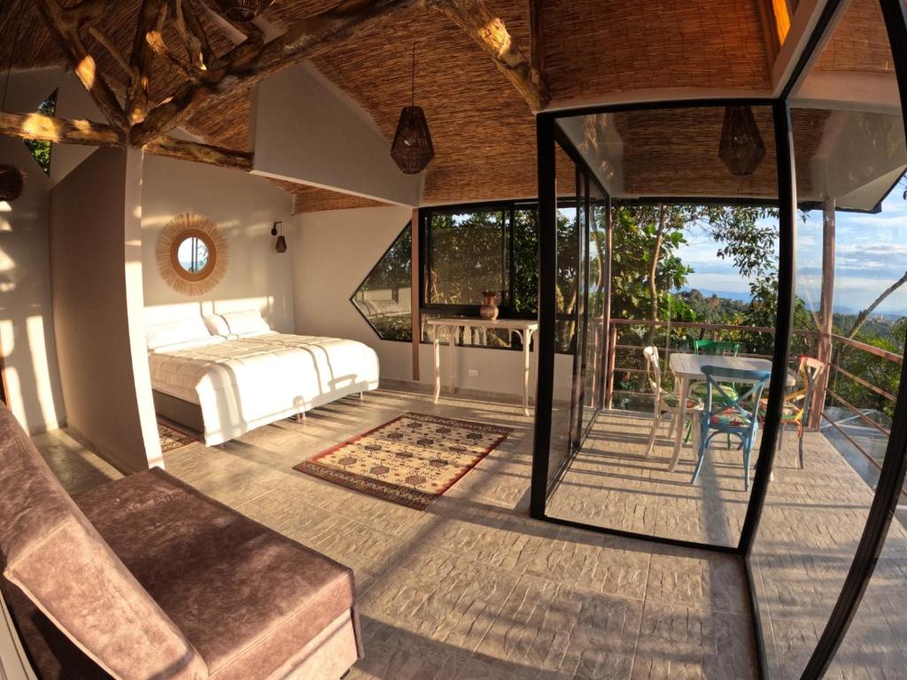 a bedroom with a bed and a table at Eco Lodge SOL- SUE in La Mesa