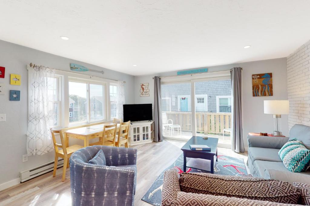 a living room with a couch and chairs and a table at Bayside on Commercial in Provincetown
