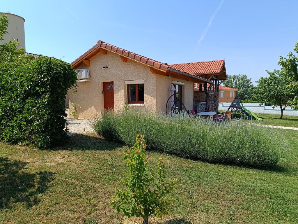 a small house in a yard with tall grass at studio avec terrasse au calme in Jayat